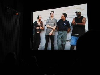 Photo taken during the screening of the movie by Paul S. Ewen, When the World Runs Fast. (Honor Among Thieves L-R: Randal Harrison-violin, Andy "Andrando" Ewen-guitar, Doug DeRosa-bass, Joey B. Banks-
