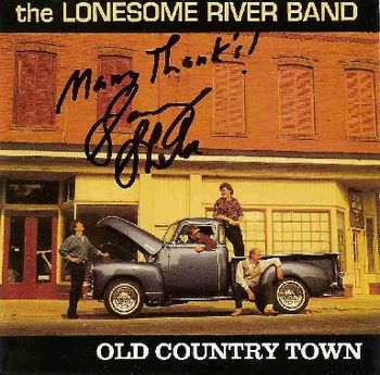 Signed by banjoist/guitarist Sammy Shelor of The Lonesome River Band (pictured on lower right)
