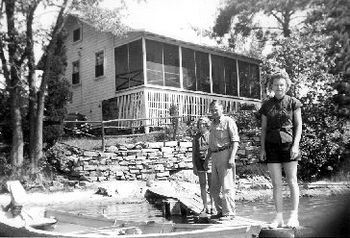 Mom & Uncle France stand in front of the cottage in July 1954 at Millsite Lake.
