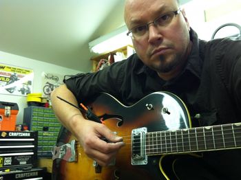 Mike setting the bridge and testing the new wiring in a vintage Gretsch Anniversary guitar.
