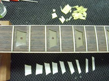 The old inlays are out, and the cavities are prepared for the new ones.
