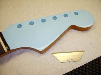 The body and headstock are sprayed matching Sonic Blue nitro lacquer
