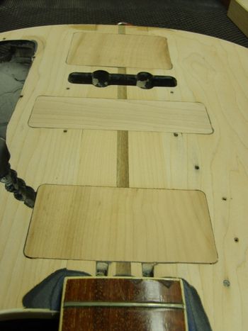 The old refinish is sanded off, and the face of the bass is leveled....
