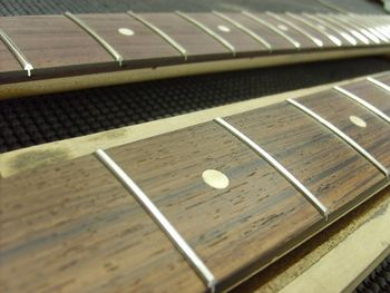 The new frets are in and roughly shaped.  I'll perform the final fret dress later.....
