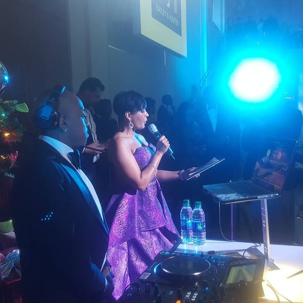 Keisha Lance Bottoms speaking at her holiday party with jermaine dupri that has on a tuxedo