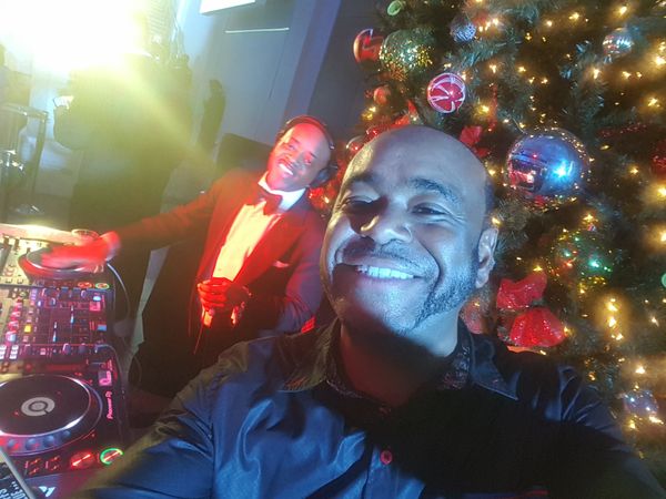 DJ TRON with Jermaine Dupri DJing with a Christmas tree background