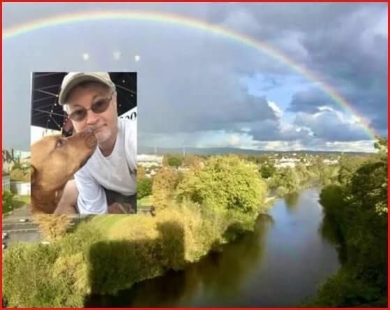 Motivational Humorist Greg Tamblyn and his dog Houdini under a rainbow at Kilkenny Castle in Ireland.