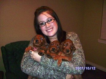 My daughter, Samantha, playing with puppies.
