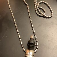 Handcrafted two skull necklace - faces owner