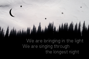 A black-and-white image of a crescent moon and a few stars hanging over a treescape. The lyrics on the image read 