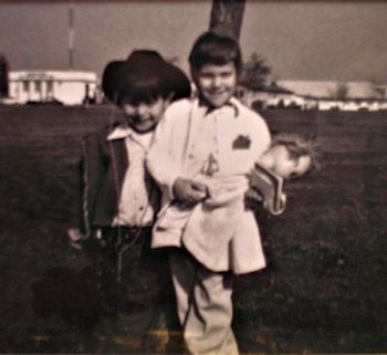 This is an old pic of my brother Victor and I. I am holding a baby doll and a purse and am hanging out with a cowboy. Typical.

