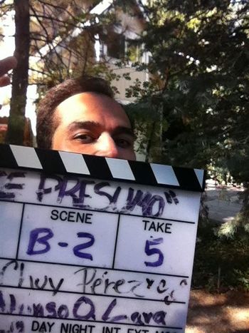 Sidow Sobrino behind the clapboard while filming on location the Movie Te Presumo
