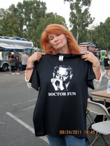Lynn Parker President of SCVB Society trying on a Doctor Fun shirt at Castaic Days Sept 2011
