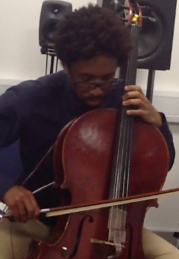 trying out the feedback system in Huddersfield, this time with bowing (click here to listen). With the same contact microphone and transducer on his body. (Once again, microphones pictured here are used only for recording purposes, and nothing is coming out of the speakers in the background, all sound comes through the cello itself).