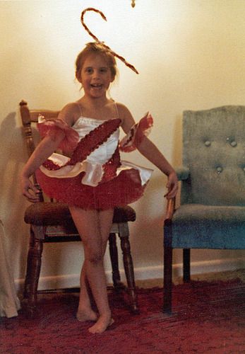 Ready for a recital at age 5. The candy cane on her head proves why she doesn't get embarrassed about what she's wearing easily.
