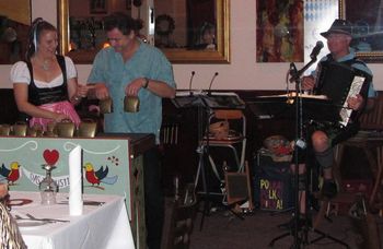 Cowbell duet with a guest at Charivari Specialty Restaurant
