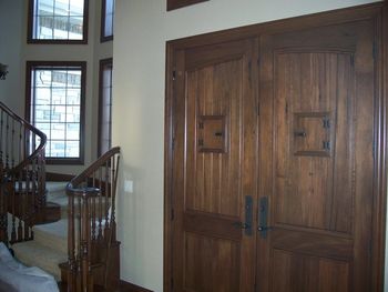 Solid wood front entry doors stained.
