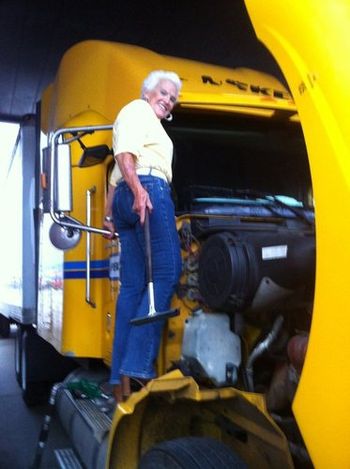 Margarette, 82, climbs up on the rig to clean the windows at the largest truck stop in America in Walcott, Iowa, June 8, 2011.
