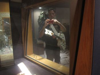 Buzz taking a photo thru the glass of the isolation booth.
