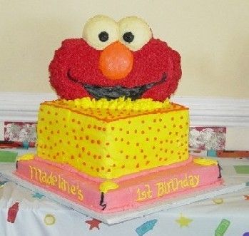 Elmo popping out of presents birthday cake
