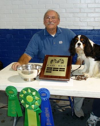Obedience competitors Thayer Arthur and Abubble Excalibur With Gusto, CD "Gus" with some of their High In Trial winnings.
