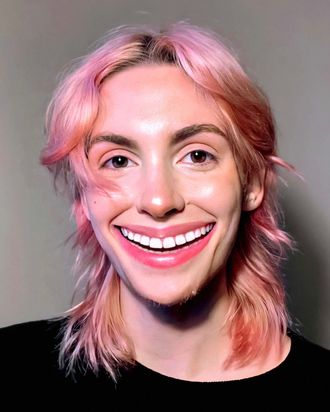 Medusa, non-binary musician; pop artist; rapper; hip-hop artist; pink hair, digitally enlarged wide smile, revealing extra teeth.