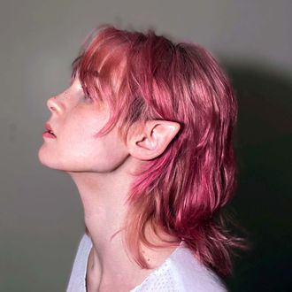 Medusa, non-binary musician; pop artist; rapper; hip-hop artist; pink shag hair, looking left in profile; pointed elf ear; Adams apple