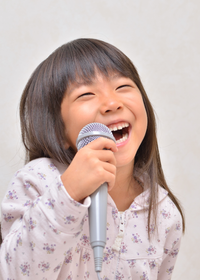 Little girl smiling and singing 