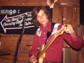 Tuning up in West Palm Beach, FL at the Dutchman Lounge in the early 70s where, as stated on the sign in the background, The Phoenix was touted to be the best Country Rock Band in The Palm Beaches, and they were....:o)
