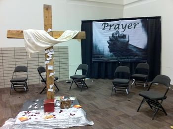 A prayer corner in the exhibit hall. People wrote their prayer requests on slips of paper and left them on the cross.
