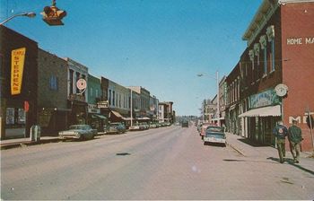 Main Street, Paris, MO. This is how I remember it. The store on the left with the big white circle is Western Auto; where I got my first guitar.
