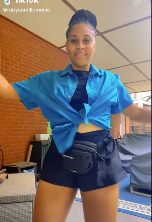 Ruby Camille on tiktok dancing in blue shirt smiling in Atlanta