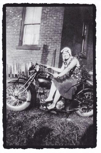 Rosie takes a break to go for a ride on Dan's Indian motorcycle.
