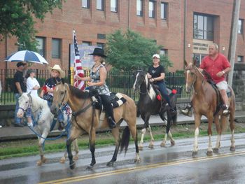 Kayla, little brother Nathan, Steve and Tammy in the local 4th of July Parade. Yes! It was pouring rain! We are riding Sugar, little pony mare, Babe and Cracker.

