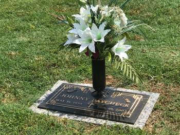 Johnny PayCheck is buried near George Jones
