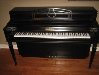 1957 Chickering Console with new Semi Gloss Black finish, New Key Covers, and a new decal.
