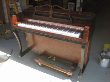 Wurlitzer mini, with rebuilt action, new rubber bumpers, new Tri-color finish, Walnut,Red Mahogany and satin ebony, new key covers, polished pedals and a matching bench
