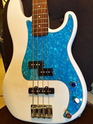 Fender P-Bass Deluxe. Olympic White with a turquoise "pearl" pickguard