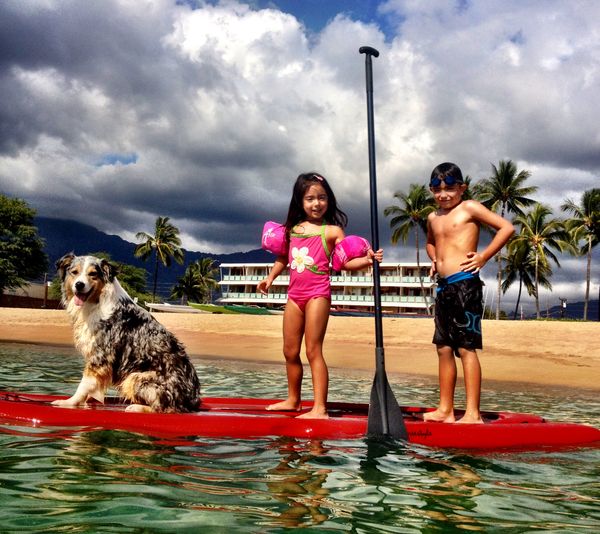 Mia & Kelvin takes Rivet out on the paddle board at Pokai Bay