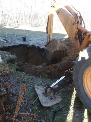 Well plumbing installation starts with well plumbing contractor digging hole