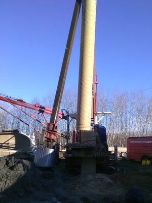 Well its a well - well drilling contractor lowering top section of well casing into place