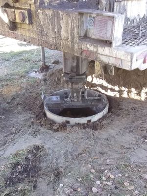 Well its a well - well drilling contractor lowering bucket into well hole