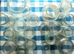 Photo of empty glass jars on checkered table cover