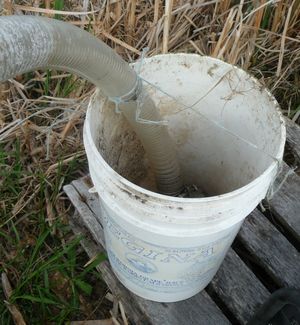 Water pump intake hose inside a pail