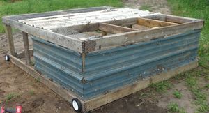 side metal secured to pastured poultry chicken tractor