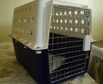 Approved Crate - hard plastic to withstand knocks and protect your cat in transit.  Screws on side ensure top and bottom of crate stay securely fastened.
