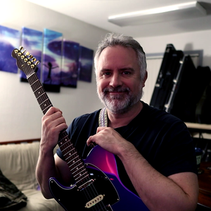 portrait of a jubilant, bearded Jason Mauer in his natural habitat, embracing a purple Telecaster with rosewood neck