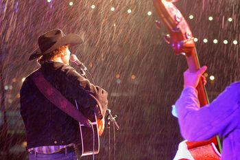 Look at the rain comin' down in sheets and drippin' of the cowboy hats. You can't stop this band from tearin' it up...
