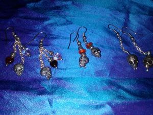 1 pair pewter dagger earrings with pewter skulls & iridescent green beads on chains; 3 with pewter skull (1 pair with orange & silver beds; 1 pair with red & clear heart beads on chains; 1 pair with no beads) - $30