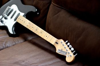 (03/04/14) This is another guitar that I will never give up. It is a Frankenstrat at its finest. I had a USA Fender Strat Plus that I never really liked the neck on and could never really get it to play how I wanted. One day I was trying to fit a Charvel neck on it and it wouldn't fit, I looked around and figured I always loved the neck on my first real guitar, a Fender Mexican Strat. The neck on the Mexican Strat was worn in from the years of playing. As soon as I put it on I knew it was meant to be. I took the badge off an old safe and and put it on the headstock and the Safeguard Strat was born. The Body is Alder and the neck is Maple with a Maple fretboard. It has Schaller locking tuners and the pickguard I purchased off a friend. For pickups It has a DiMarzio Tone Zone in the bridge and a Fender Texas Special in the middle with a Seymour Duncan 59 in the neck.
